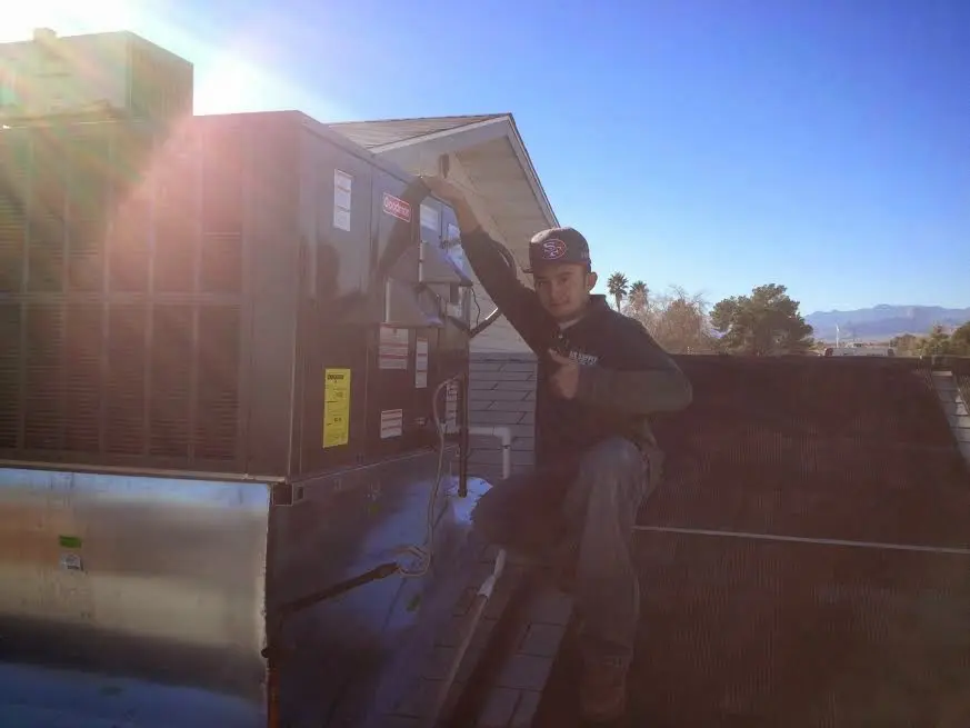 HVAC technician performing HVAC Inspection on a rooftop unit in South Whittier